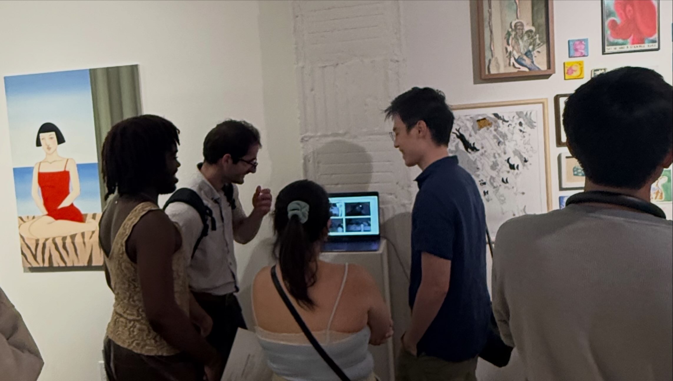 Visitors at FLOHAUS Gallery watching Look at Her on a laptop